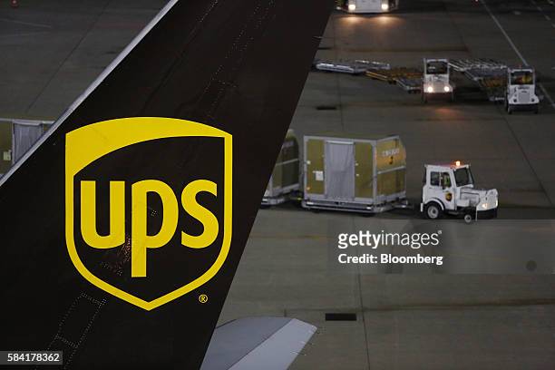 United Parcel Service Inc. Signage is displayed on the tail section of a cargo jet on the tarmac at the UPS Worldport facility in Louisville,...