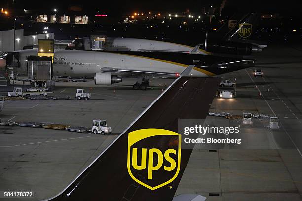 Package containers are unloaded from cargo jets during the night package sort at the United Parcel Service Inc. Worldport facility in Louisville,...