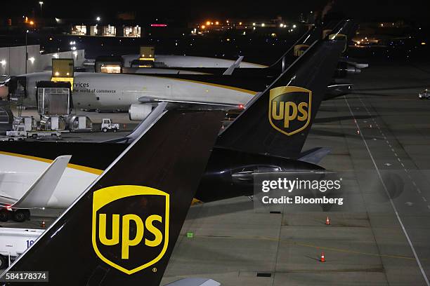 United Parcel Service Inc. Signage is displayed on the tail sections of cargo jets on the tarmac at the UPS Worldport facility in Louisville,...