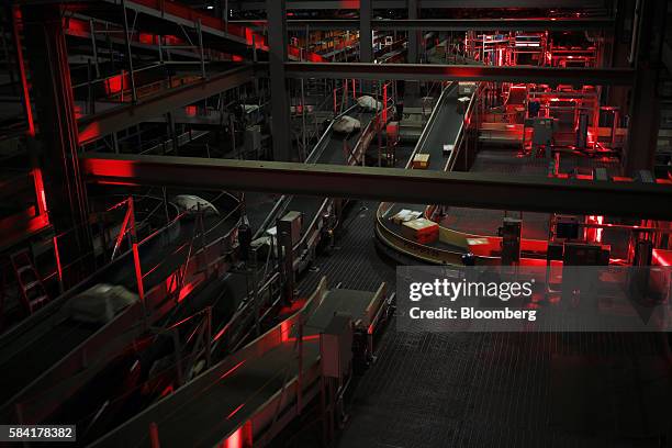 Packages move down conveyor belts during the night package sort at the United Parcel Service Inc. Worldport facility in Louisville, Kentucky, U.S.,...