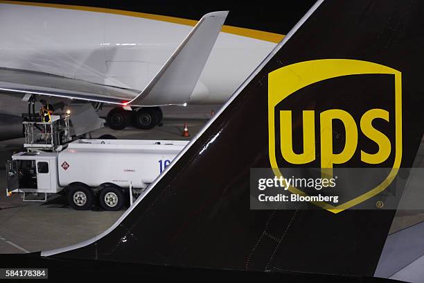United Parcel Service Inc. Signage is displayed on the tail section of a cargo jet on the tarmac at the UPS Worldport facility in Louisville,...