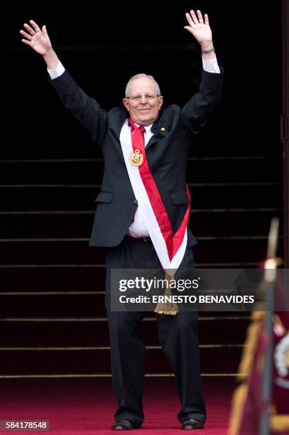 Peru´s President Pedro Pablo Kuczynski waves to supporters as he arrives to the Government Palace after his swearing-in ceremony held at the Congress...