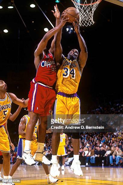 Shaquille O'Neal of the Los Angeles Lakers fights to rebound the ball against Lorenzen Wright of the Los Angeles Clippers during a game in 1999 at...