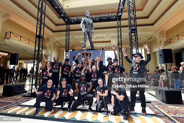 Performers from "Michael Jackson ONE by Cirque du Soleil" pose in front of Michael Jackson's 10-foot-tall HIStory statue after is was unveiled at the...