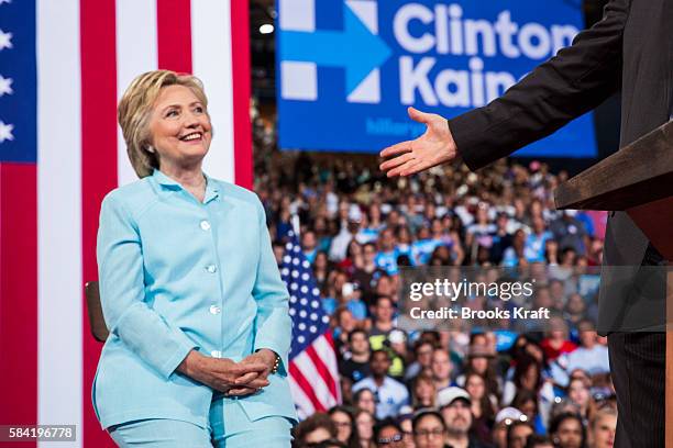 Democratic presidential candidate former Secretary of State Hillary Clinton listens to her running mate Sen. Tim Kaine speak for the first time at a...