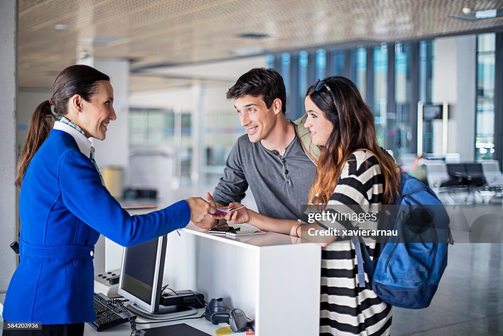Young couple boarding to the plane at airport