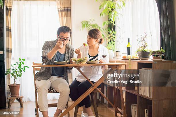 mid adult couple eat lunch with wine - real wife sharing 個照片及圖片檔