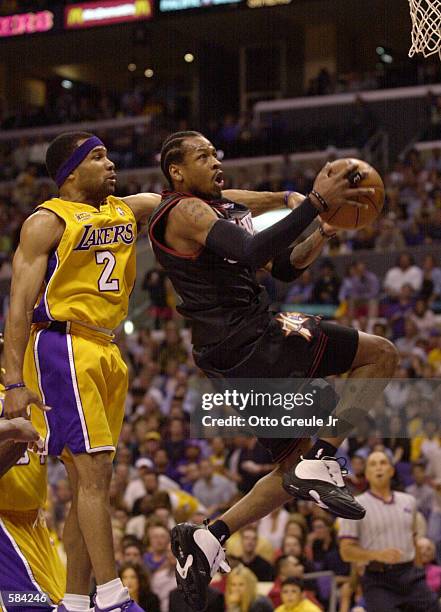 Allen Iverson of the Philadelphia 76ers drives to the basket past Derek Fisher of the Los Angeles Lakers during Game 2 of the NBA Finals at the...