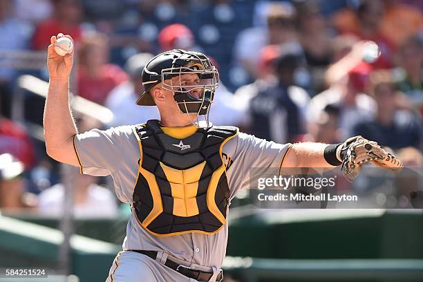 Erik Kratz of the Pittsburgh Pirates looks to throw the ball during a baseball game against the Washington Nationals at Nationals Park on July 17,...