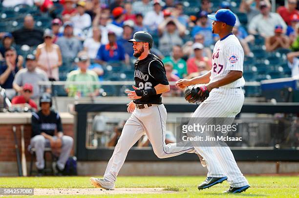 David Dahl of the Colorado Rockies scores a run in the ninth inning after a wild pitch from Jeurys Familia of the New York Mets at Citi Field on July...