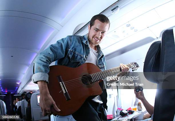 Ryan Hahn of Local Natives performs live, acoustic set at 35,000 feet on Virgin America Flight ahead of Lollapallooza held on Virgin America flight...