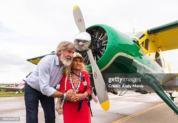 Harrison Ford has his photo taken with Cherie Lee Parcher of Milwaukee in front of Ford's de Havilland Beaver at the EAA's AirVenture Air Show on...