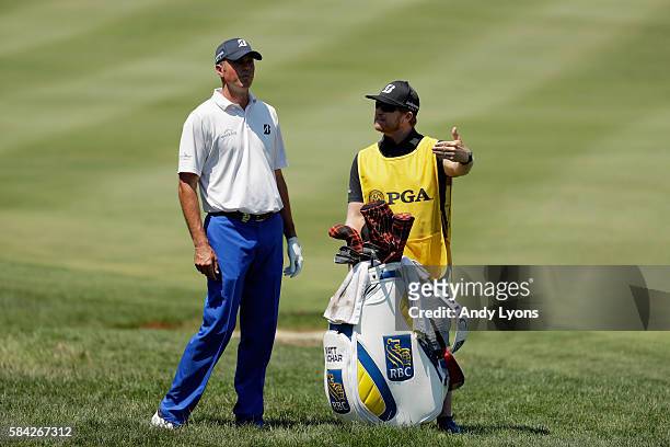 Matt Kuchar of the United States and caddie John Wood on the first fairway during the first round of the 2016 PGA Championship at Baltusrol Golf Club...