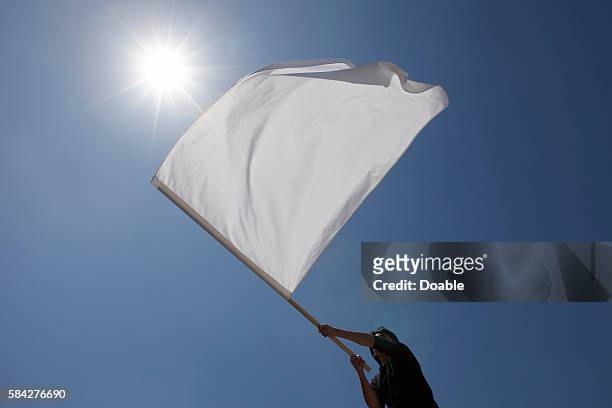 person waving flag - white flag stockfoto's en -beelden
