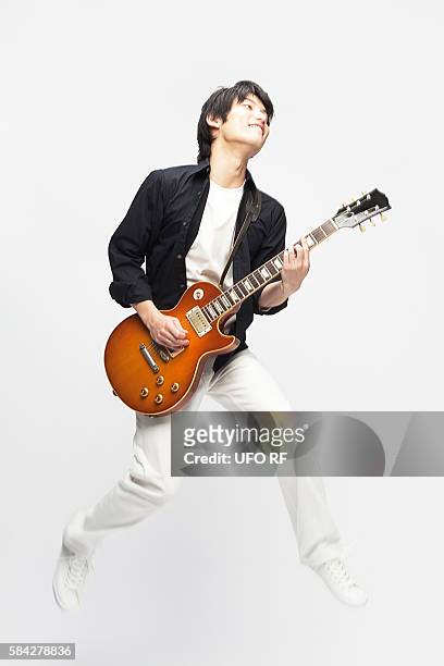 young man playing electric guitar - vintage electric guitar stock pictures, royalty-free photos & images