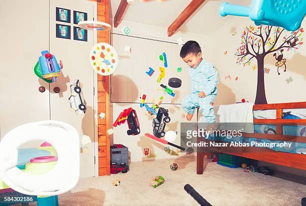 boy jumping in his room. - auckland city busy stockfoto's en -beelden