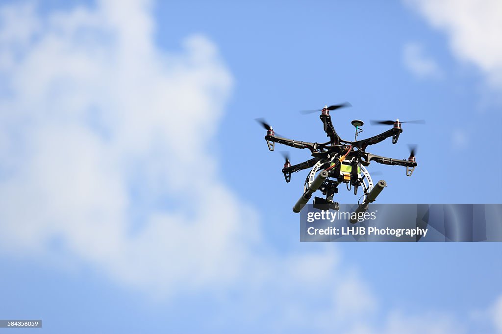 Uav drone flying with camera at blue sky