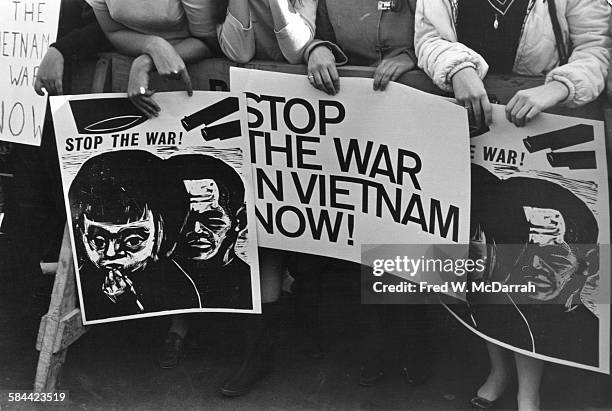 Close-up of signs held by protestors at an anti-Viet Nam War demonstrators on Fifth Avenue, New York, New York, October 17, 1965. Visible signs read...