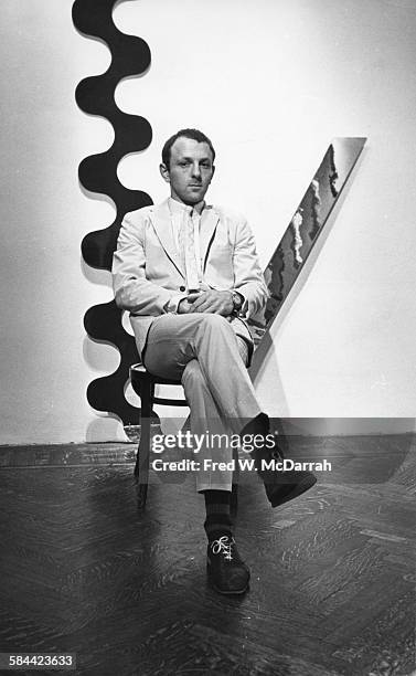 Portrait of British Pop artist Gerald Laing as he poses with his work at the Richard L Feigen Gallery, New York, New York, November 6, 1965.