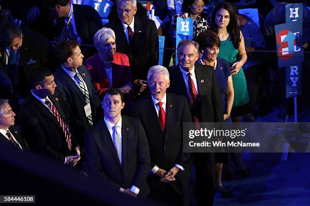 Former US President Bill Clinton stands with US Vice President nominee Tim Kaine along with his wife Anne Holton and daugher Annella Kaine ; and Marc...