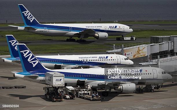 All Nippon Airways Co. Aircraft are seen at Haneda Airport in Tokyo, Japan, on Thursday, July 28, 2016. ANA is scheduled to release full-year...