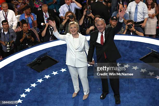 Democratic presidential candidate Hillary Clinton and US Vice President nominee Tim Kaine stand on stage after delivering a speech on the fourth day...