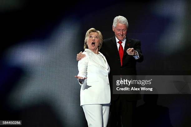 Democratic presidential candidate Hillary Clinton along with her husband, former US President Bill Clinton, acknowledge the crowd on the fourth day...