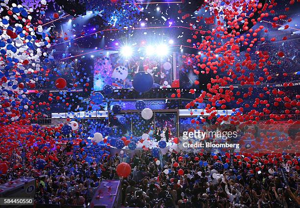 Balloons and confetti drop as Hillary Clinton, 2016 Democratic presidential nominee, stands on stage during the Democratic National Convention in...