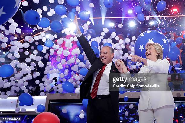 Democratic presidential candidate Hillary Clinton and US Vice President nominee Tim Kaine stand on stage at the end on the fourth day of the...