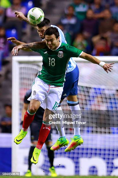 Erick Torres of Mexico fights for the ball with Mauricio Martinez of Argentina during an U-23 International Friendly between Mexico and Argentina at...