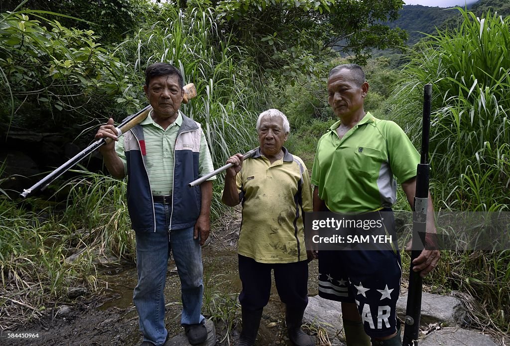 Indigenous Hunting Rights Tama Talum , an aboriginal hunter, poses for photos with fellow tribe ...