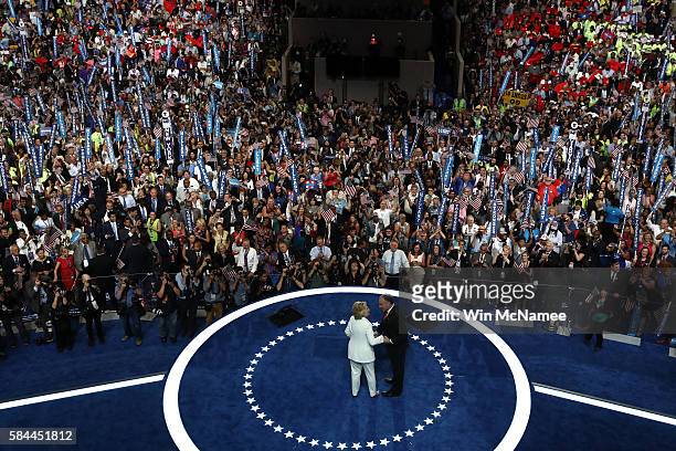 Democratic presidential candidate Hillary Clinton and US Vice President nominee Tim Kaine acknowledge the crowd at the end on the fourth day of the...