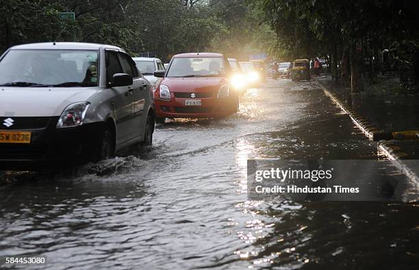 Vehicles wade through waterlogged area after the heavy evening downpour on July 28, 2016 in Gurgaon, India.The Gurgaon Police issued an advisory on...