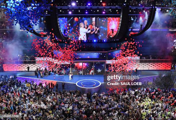 Balloons and confetti fall following a speech by Democratic presidential nominee Hillary Clinton after accepting the nomination during the fourth and...