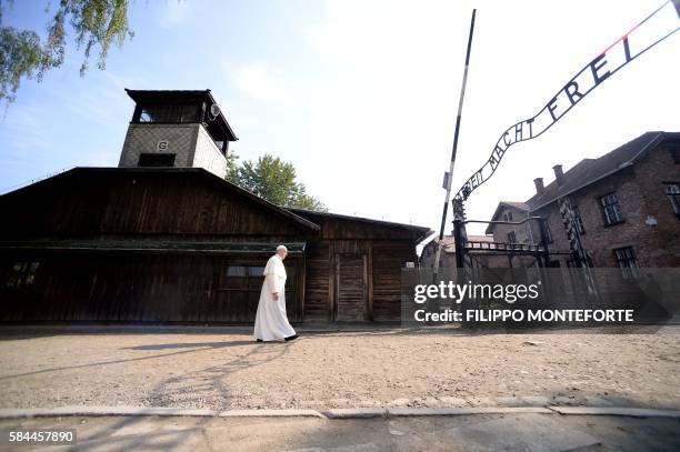 Pope Francis walks towards the main entrance with the lettering "Arbeit Macht Frei" at the former Nazi German Auschwitz-Birkenau death camp on July...