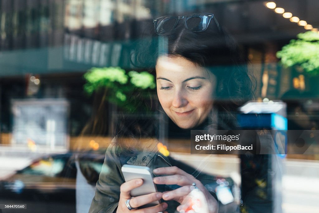 Playing With Smartphone At Café