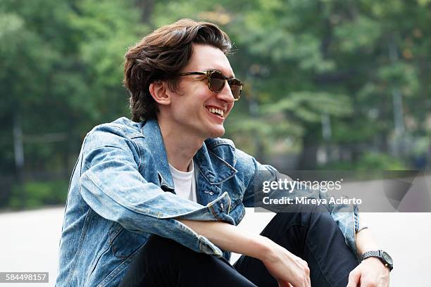 hipster guy laughing in park - man sunglasses stock pictures, royalty-free photos & images