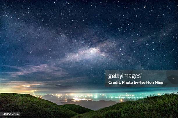milky way over hong kong city lights - dusk stars stock pictures, royalty-free photos & images
