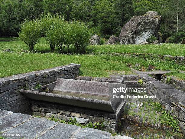 ancient washing place in a small village in maggia valley, ticino, southern switzerland - washboard laundry stock pictures, royalty-free photos & images