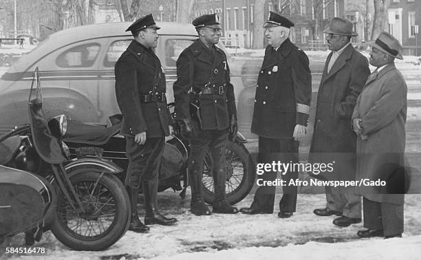 Major Edward Kelly of the Washington DC police speaks with two new African-American patrolmen as Edward Harris and William A Powell look on,...