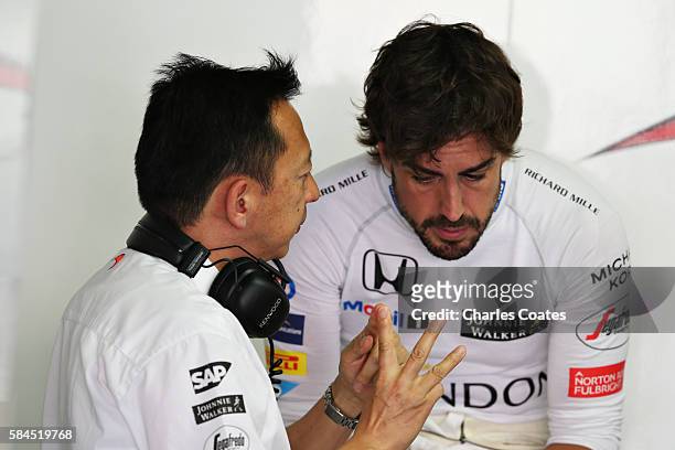 Yusuke Hasegawa, Head of Honda F1 and Fernando Alonso of Spain and McLaren Honda talk in the garage during practice for the Formula One Grand Prix of...