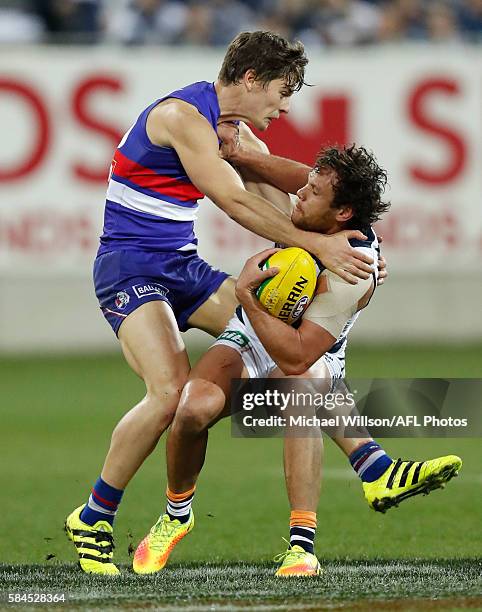 Steven Motlop of the Cats is tackled by Josh Dunkley of the Bulldogs during the 2016 AFL Round 19 match between the Geelong Cats and the Western...