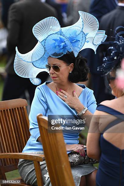 Guests compete for L'Ormarins best dressed competition themed "blue and white" at the Qatar Goodwood Festival 2016 at Goodwood on July 29, 2016 in...