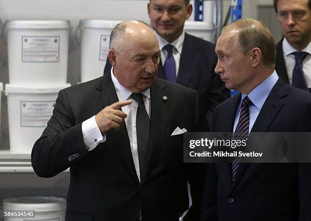 Russian President Vladimir Putin talks to billionaire, businessman and owner of Acron Group Viatcheslav Kantor while visiting the Acron plant on July...