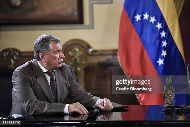 Igor Sechin, chief executive officer of Rosneft PJSC, listens as Nicolas Maduro, president of Venezuela, not pictured, speaks to the media after...