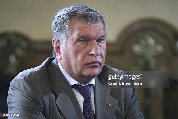 Igor Sechin, chief executive officer of Rosneft PJSC, listens as Nicolas Maduro, president of Venezuela, not pictured, speaks to the media after...