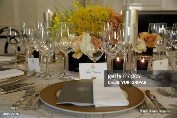 Table settings are viewed in the State Dining Room of the White House in Washington, DC on July 29 in advance of the state dinner honoring the visit...