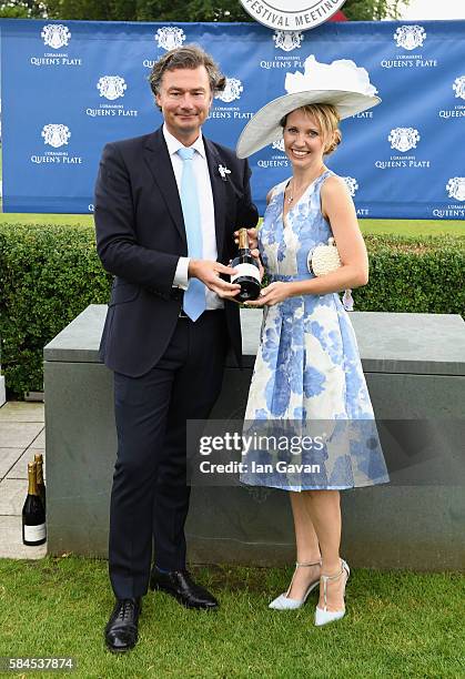 Sarah Weston is announced as winner of the L'Ormarin best dressed competition by Laurent Feniou, Managing Director of Cartier UK, at the Qatar...