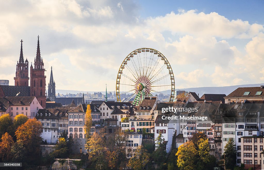 The skycape of The huge Ferris wheel and Basel Cathedral