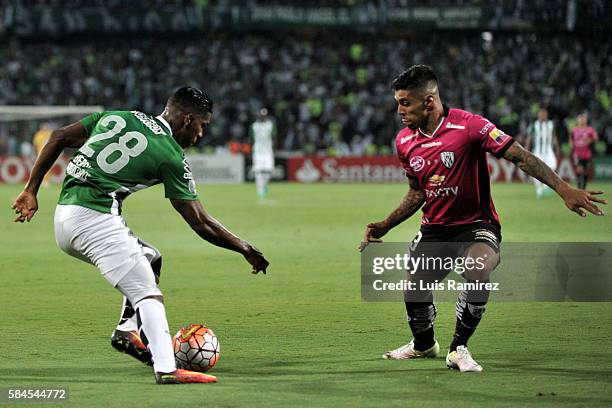 Orlando Berrio of Atletico Nacional vies for the ball with Emiliano Tellechea of Independiente del Valle during a second leg final match between...